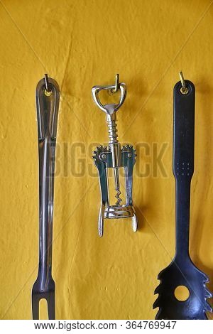 Bottle opener for beer and wine hanging on a kitchen wall