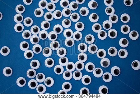 Googly Toy Eyes On Classic Blue Background. Concept Of Personal Data Security, Surveillance, Espiona