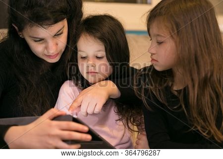 Mother Doing Lessons With Children On A Tablet