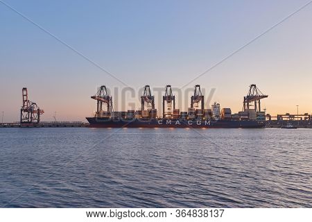 ROTTERDAM, THE NETHERLANDS - SEPTEMBER 20, 2019: Huge container ship in port being loaded in the Euromax container terminal in the Port of Rotterdam, busiest port cargo port of Europe