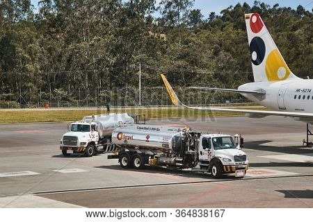 MEDELLIN, COLOMBIA - APRIL 23, 2019: Tank trucks arrive to refuel a jet aircraft at Jose Maria Cordova International Airport, in Medellin, airliner refuelling