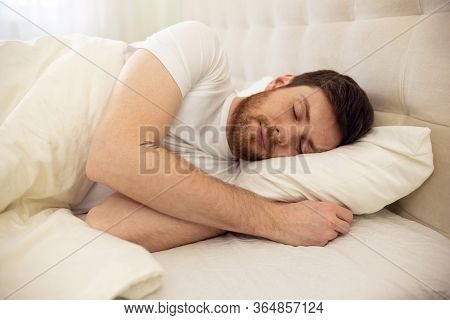 Handsome Man Sleeping Cozily In Bed At Home. Sweet Dreaming. Close Up