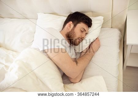 Handsome Man Sleeping Cozily In Bed At Home. Sweet Dreaming. Up Down View