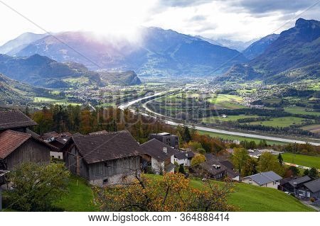 Scenic Aerial View Of Hillside Villages In Triesenberg And The River Rhine, Natural Border Of Liecht
