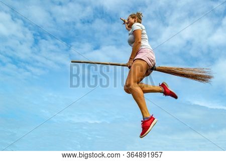 Young Woman Flying On The Broom In The Blue Sky Of Siquijor