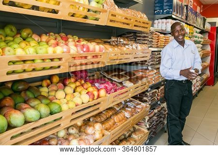 Grocery Store Staff Packing Shelves At Local Pick 'n Pay Spaza Shop