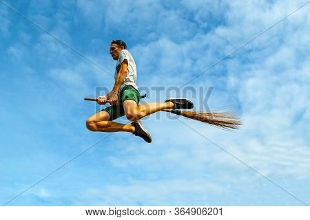 Young Man Flying On The Broom In The Blue Sky Of Siquijor