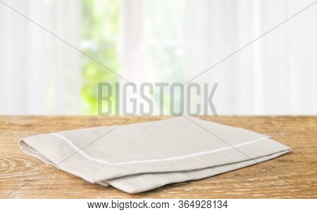 Beige Cotton Napkin On A Wooden Table