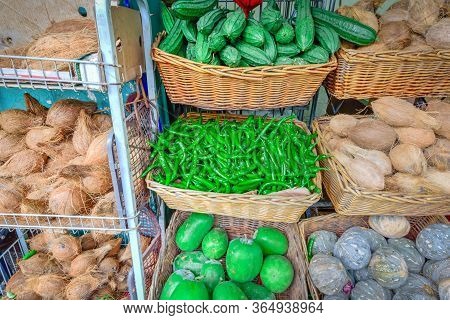 Colorful Vegetable Stall In Little India, Singapore With Luffa Acutangula, Coconut, Acorn Squash