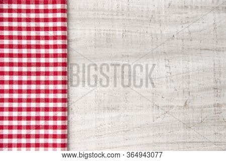 Red Cotton Checkered Fabric Side View On A Wooden Table