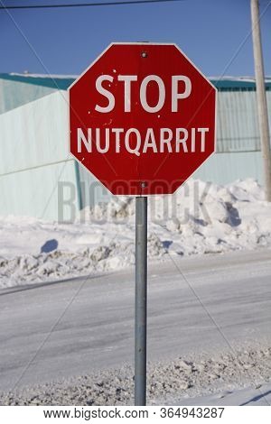 Red Stop Sign In English And Inuinnaqtun In The Community Of Cambridge Bay, Nunavut