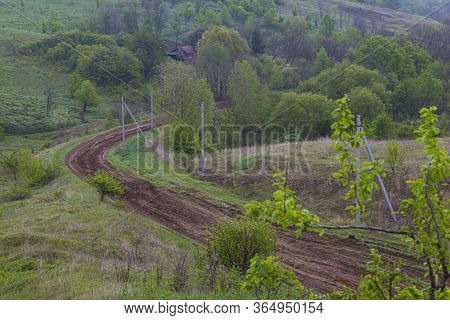 Beautiful Colorful Hills Covered Forest In Fog. Winding Dirt Road Winds Through The Green Hills. Ukr