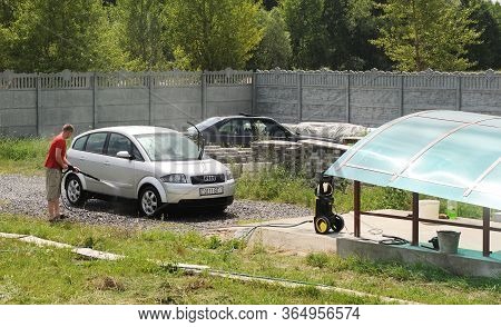 Minsk Belarus-02.07.2012:a Guy Washes An Audi A2 Car. A Classic Compact German Car.