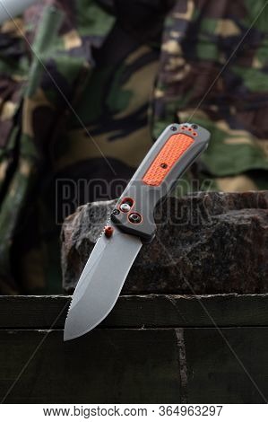 A Sharp Bright Knife For A Tourist And A Hunter. Hunting Knife With An Orange Handle.