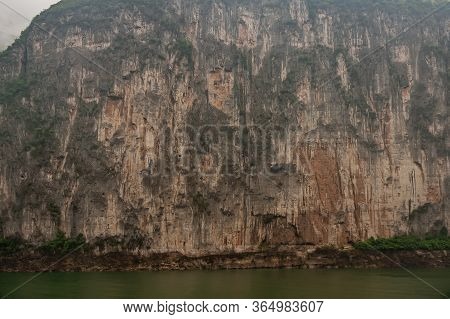 Baidicheng, China - May 7, 2010: Qutang Gorge On Yangtze River. Straigth Down Brown Cliff With Some 