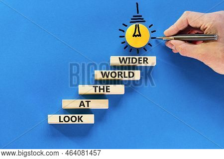 Look At The World Wider Symbol. Concept Words Look At The World Wider On Wooden Blocks On A Beautifu