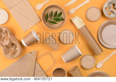 Eco-friendly Tableware - Kraft Paper Food Packaging Over Orange Background. Street Food Paper Packag