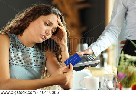 Worried Customer Paying Expensive Bill With Credit Card In A Restaurant