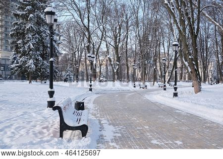 Benches In The Winter City Park. Filled Up With Snow.