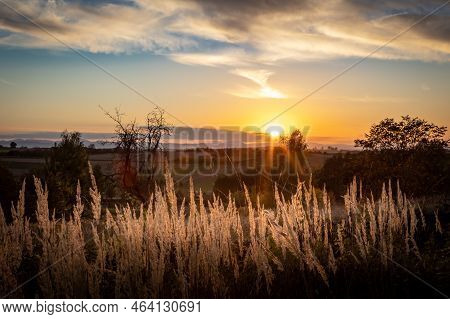 Sunset In Sleza Massif, Poland. Autumnal Landscape With Golden Meadow Grass In Foreground.