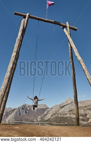 Huge Swing Surrounded By Mountains In Riano Village. Spain