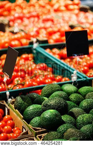 Fresh Colourful Vegetables: Green Avocado And Red Cherry Tomatoes In Boxes At Market.
