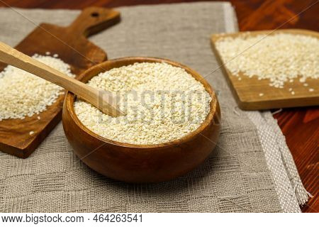 White Sesame Seeds In Wooden Bowl. Organic Benne Grains For Healthy Food, Boosting Immunity Diet And