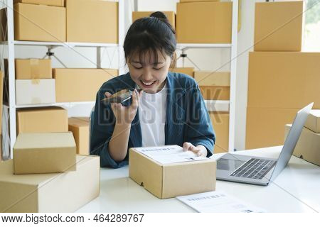 Young Female Small Business Enrtrepreneur, Online Store Owner Working On Laptop With Boxes On Desk A