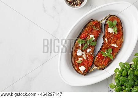 Eggplants. Baked Halves Of Eggplants  Stuffed With Sauce, Chopped Tomatoes, Sweet Pepper, Feta Chees
