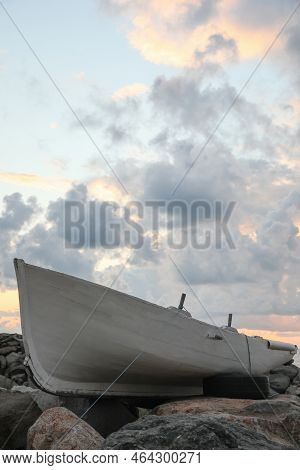 Picturesque View Of Sky With Heavy Clouds And Boat On Coast