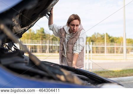 Woman In Islam Lousy Car With The Hood Up Trying To Find The Cause Of The Breakdown Of The Car
