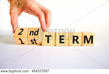 First Or Second Term Symbol. Businessman Turns Wooden Cubes And Changes Words '1st Term' To '2nd Ter