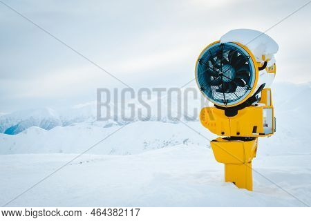 Yellow Snow Cannon Under Snow In Gudauri Ski Resort In Snowy Mountains After Fresh Snow Fall. Good S
