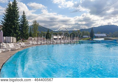 08.18.2022, Aya, Altai Krai, Russiaa Large Swimming Pool With Clear Water In The Open Air Against Th