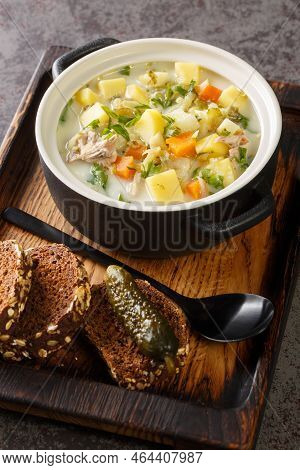 Creamy Pickle Soup Zupa Ogorkowa Closeup On The Pot On The Wooden Tray. Vertical