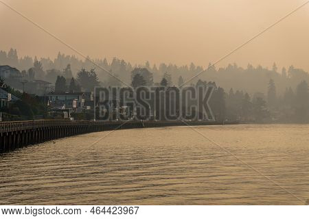 Smoke Fills The Air With Waterfront Homes And A Boardwalk Below In Redondo Beach, Washington.