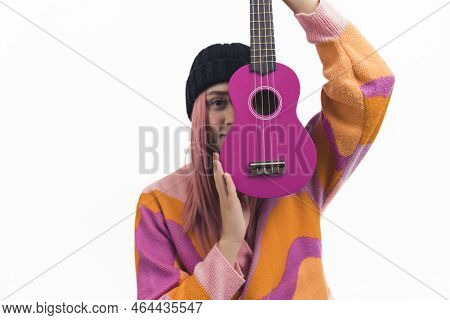 Musical Passion Concept. Medium Closeup Shot Of Young Caucasian Pink-haired Teenage Girl In A Black 