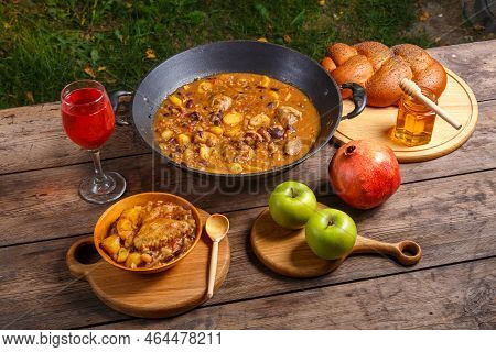 Festive Table For Rosh Hashanah Cholent, Pomegranate, Wine, Honey, Apples, Challah. Horizontal Photo