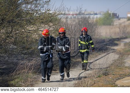 Bucharest, Romania - April 5, 2022: Firefighters Try To Extinguish A Wildfire Of Vegetation In The V