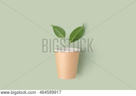 Eco - Friendly Tableware On Green Background. Top View. Plastic Free Set Of Brown Paper Utensil. Str