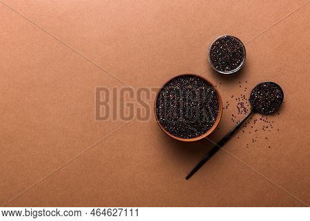 Quinoa Seeds In Bowl And Spoon On Colored Background. Healthy Kinwa In Small Bowl. Healthy Superfood