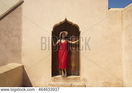 Sexy Tourist At The Gate Of The Fortress Of The Menara Gardens Of Marrakech Enjoy The Construction O