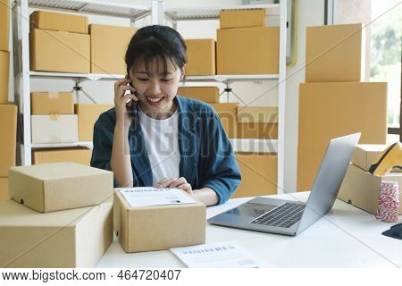 Young Female Small Business Enrtrepreneur, Online Store Owner Working On Laptop With Boxes On Desk A
