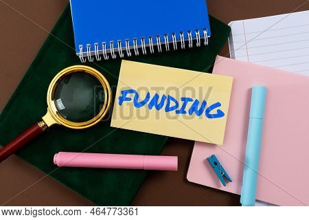 Hand Writing Sign Funding. Concept Meaning The Process Of Growing Progressively Less In Size, Amount