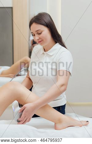 Cosmetologist Using Endospheres Therapy Machine On A Female