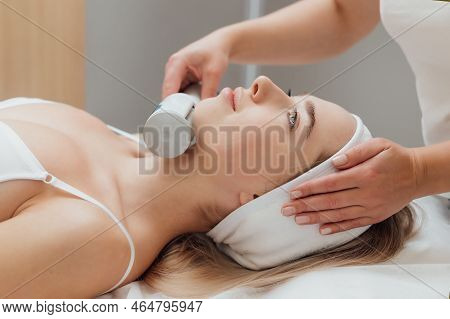 Cosmetologist Using Endospheres Therapy Machine On A Females Face