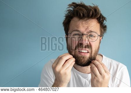 Man Woke Up After A Party, He Touches His Beard And Is Puzzled By His Untidy Appearance. Copy Space.