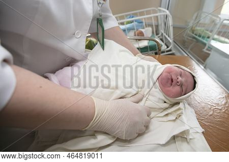 Neonatology. A Newborn In A Special Incubator. Medical Staff Caring For A Newborn In The Hospital.