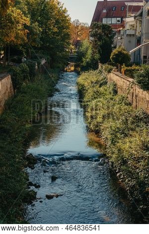 Beautiful Small River With Clean And Clear Water Front Of Colorful Autumn Trees And Small Old Town O