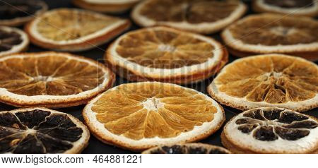 Round Dried Slices Of Natural Orange On A Black Background As A Background